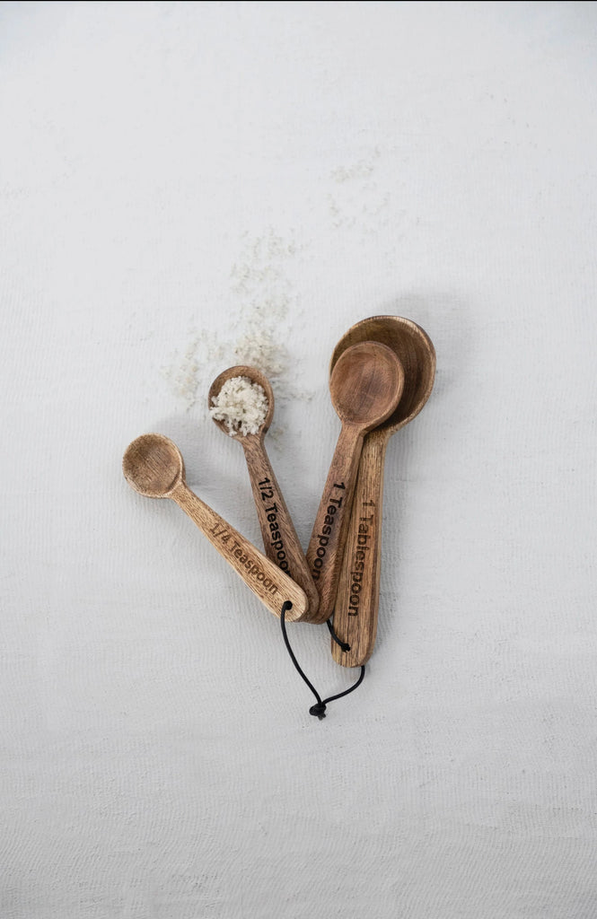 mango wood measuring spoons on a white background