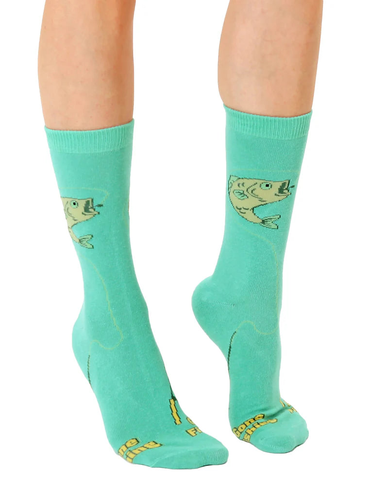 Teal socks with fish design worn by a person on a white background