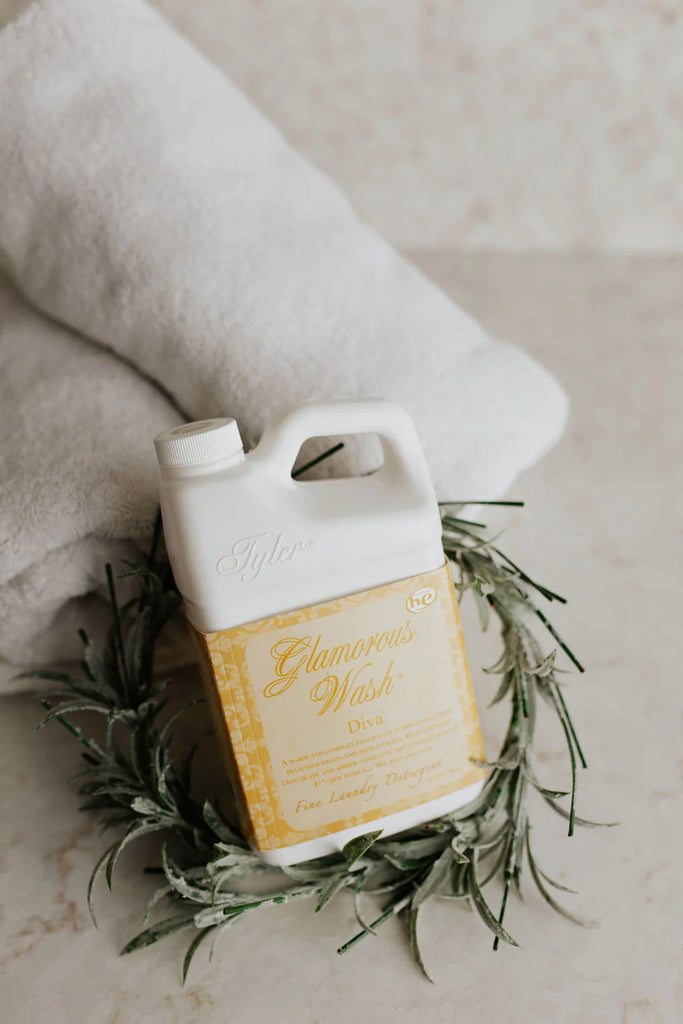 Tyler candle company laundry detergent on a marble background with a towel in the backgorund