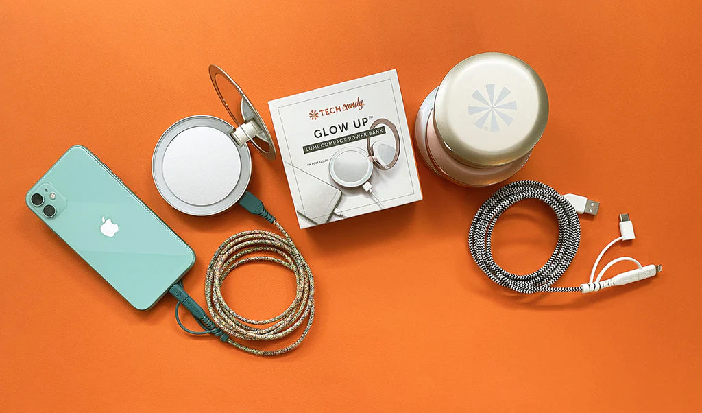 Collection of tech accessories including a phone, headphones, and a bottle on an orange background