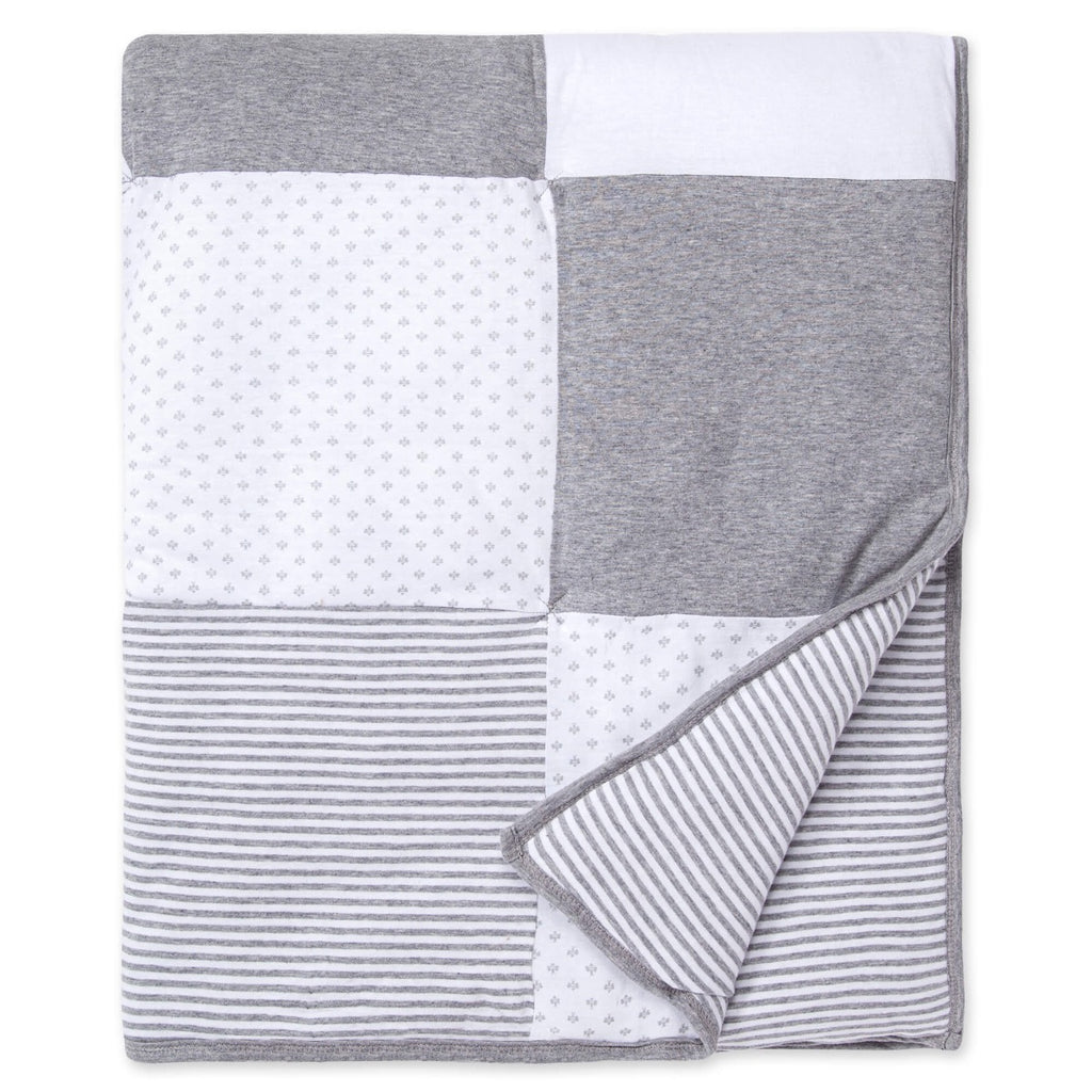 gray mixed pattern baby quilt on a white background