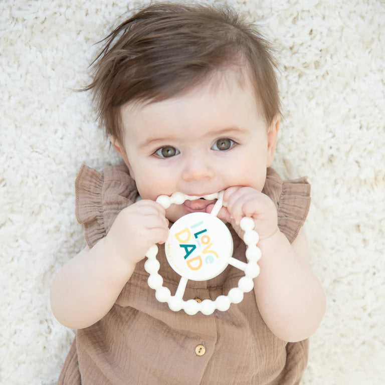 Bella tunno happy teether on a white background being used by a baby