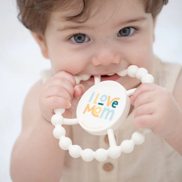 Bella tunno happy teether on a white background being used by a baby