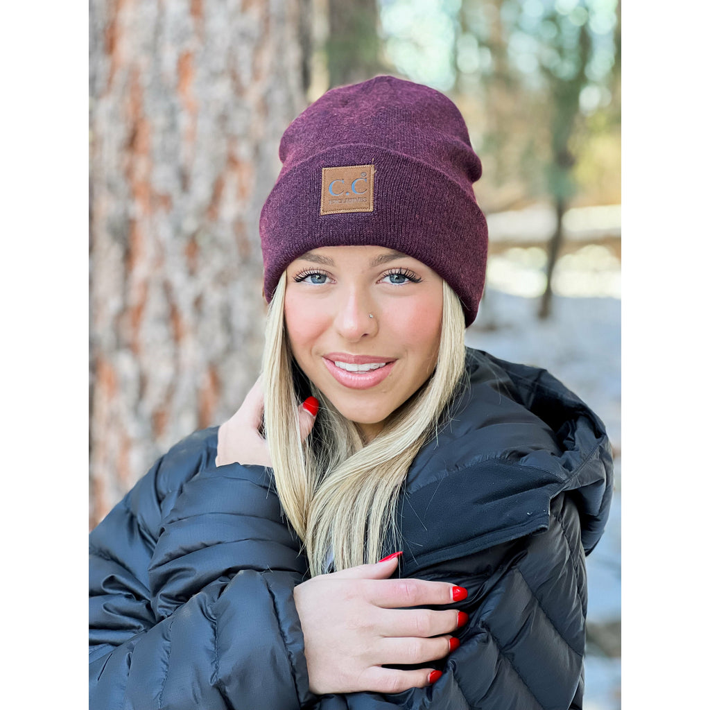 girl wearing cc soft ribbed leather patch beanie in the woods