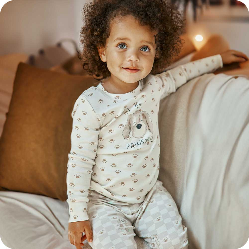 warmies pj set being worn by a child on a couch