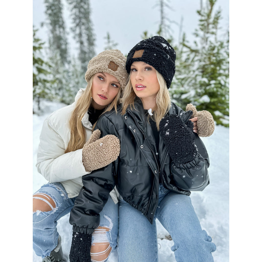 girls wearing sherpa cuffed cc beanies in the snowy woods