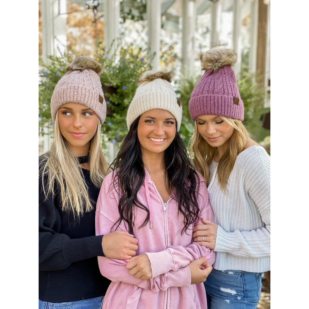 girls wearing soft cuff cable knit fur pom cc beanie in the woods