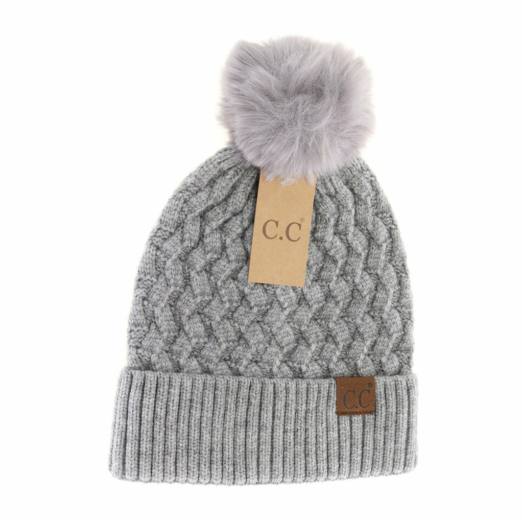 woven cable knit matching pom cc beanie on a white background