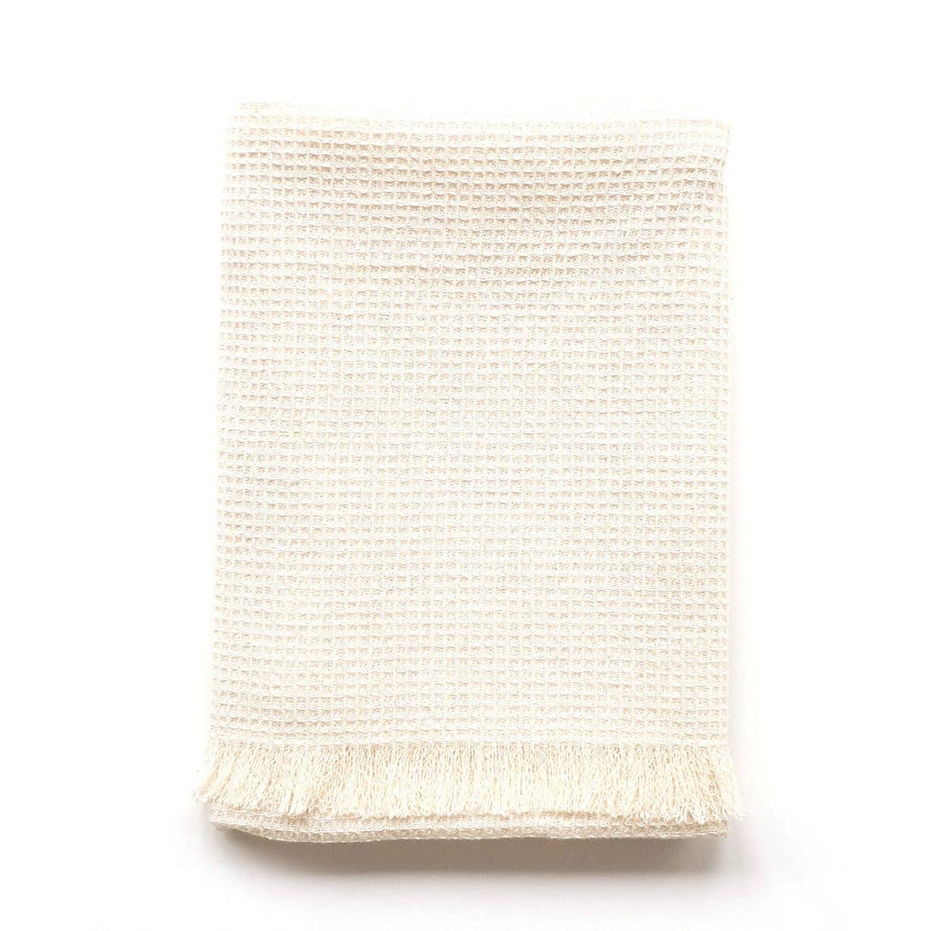 natural waffle tea towel with fringe on a white background