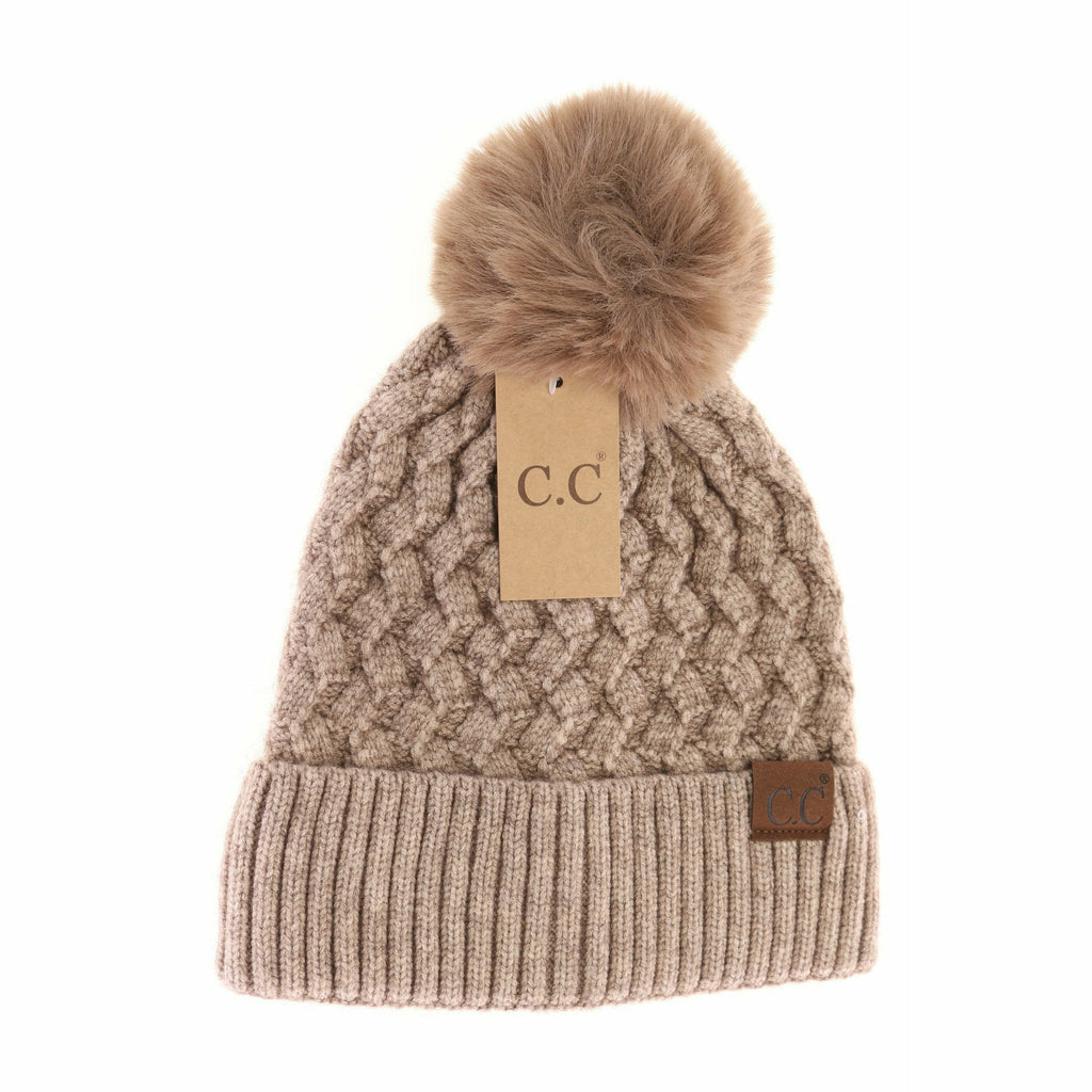 woven cable knit matching pom cc beanie on a white background