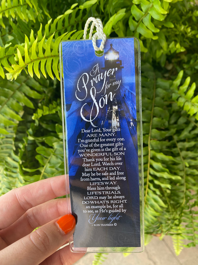 A Prayer for my son A prayer for my mom Double sided, plastic cover spiritual bookmark being held up in front of a green fern 