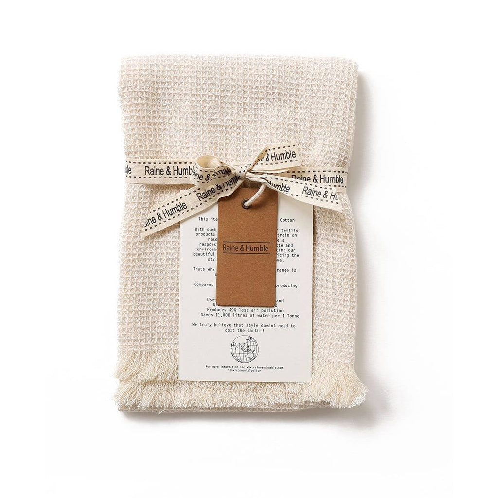 natural waffle tea towel with fringe on a white background