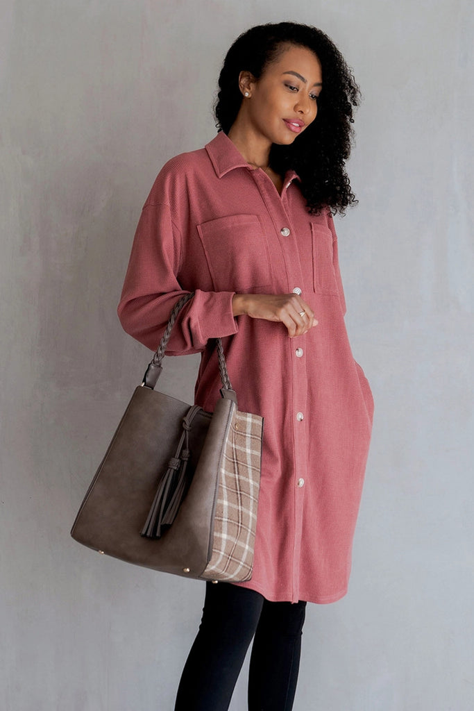 Jen & Co red and plaid bag in a bag on a white background being carried by a woman in a pink shirt