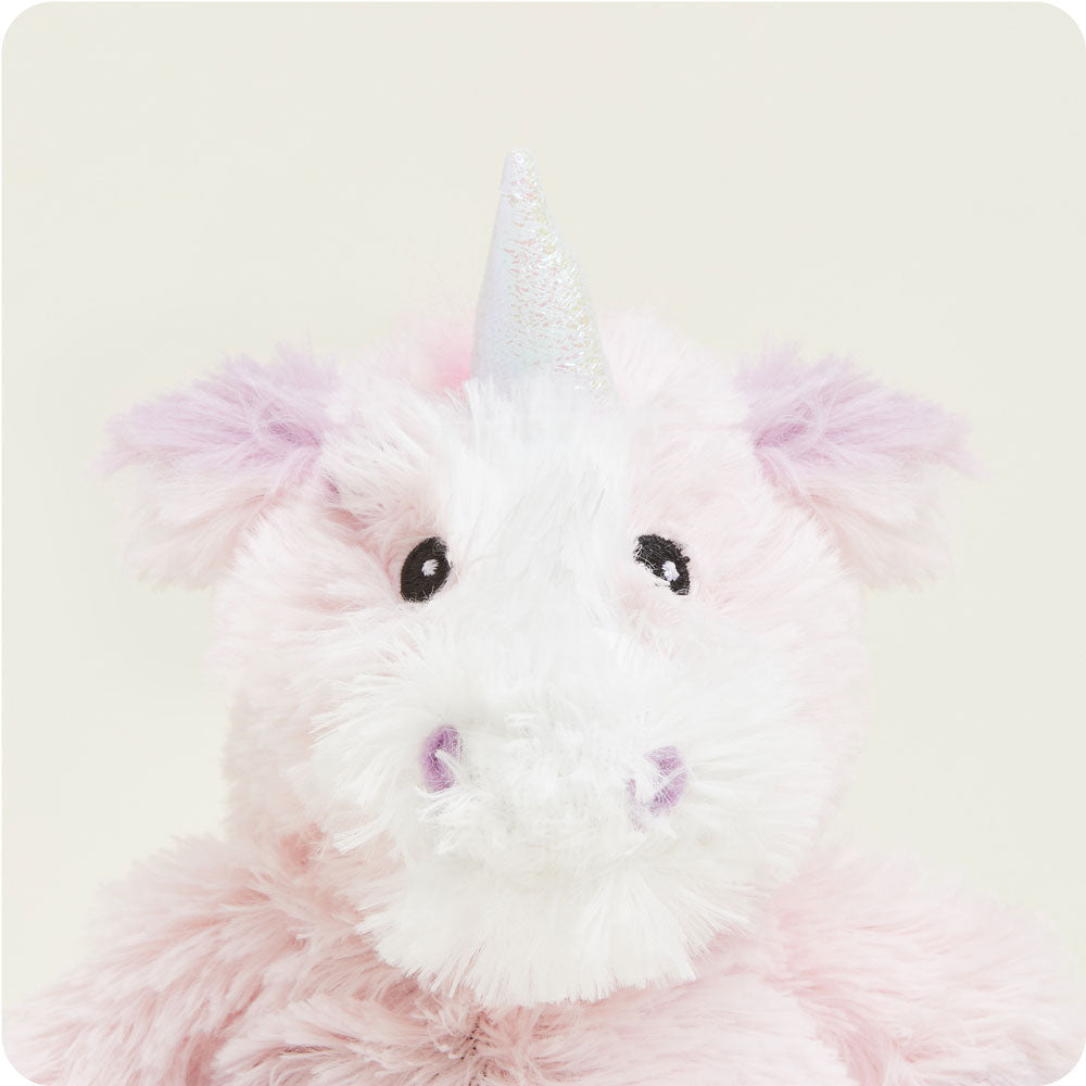 warmies pink unicorn on a cream background