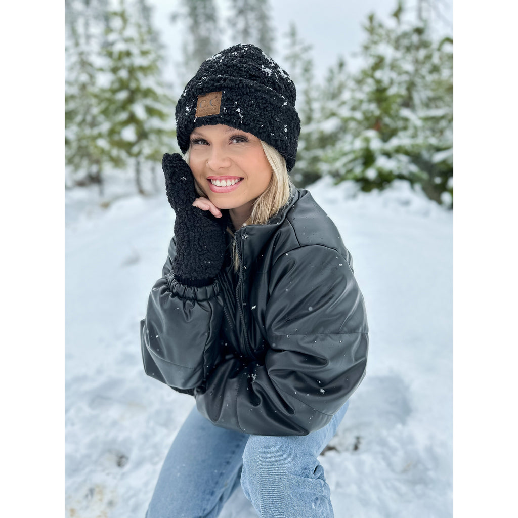girl wearing sherpa cuffed cc beanie in the snowy woods