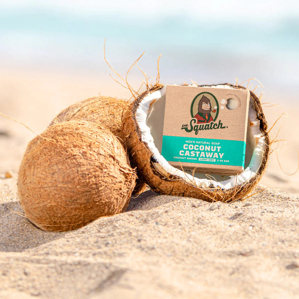 dr squatch coconut castaway soap in a coconut on the beach