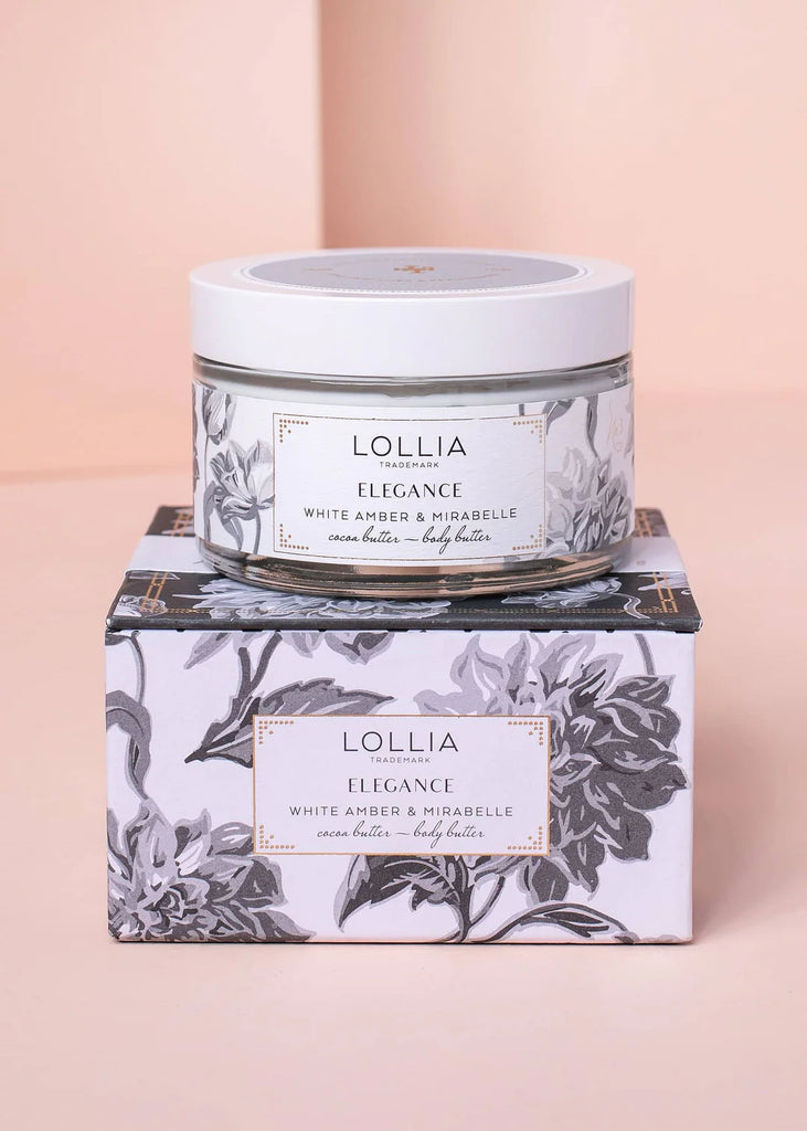 Lollia Elegance body butter jar on a matching box with floral design on a pink background