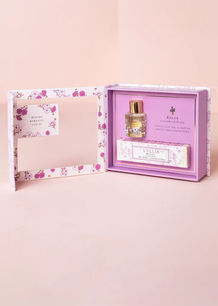 Perfume bottle and packaging with floral design on a pink background