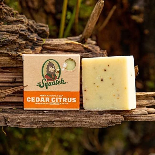 dr. squatch cedar citrus soap on a log in the forrest