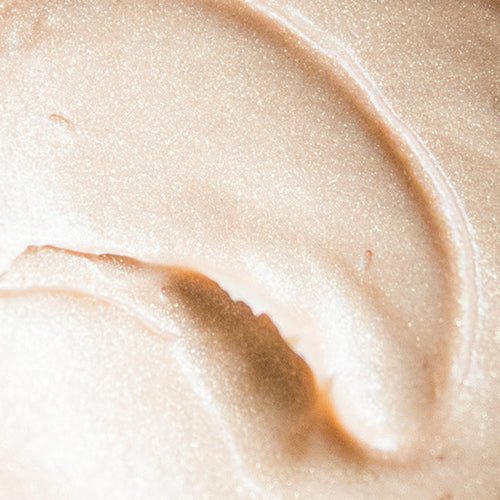 Close up picture of beekman 1802's pot of gold shimmer body cream 8.0 fl oz product to show the shimmer of the body cream