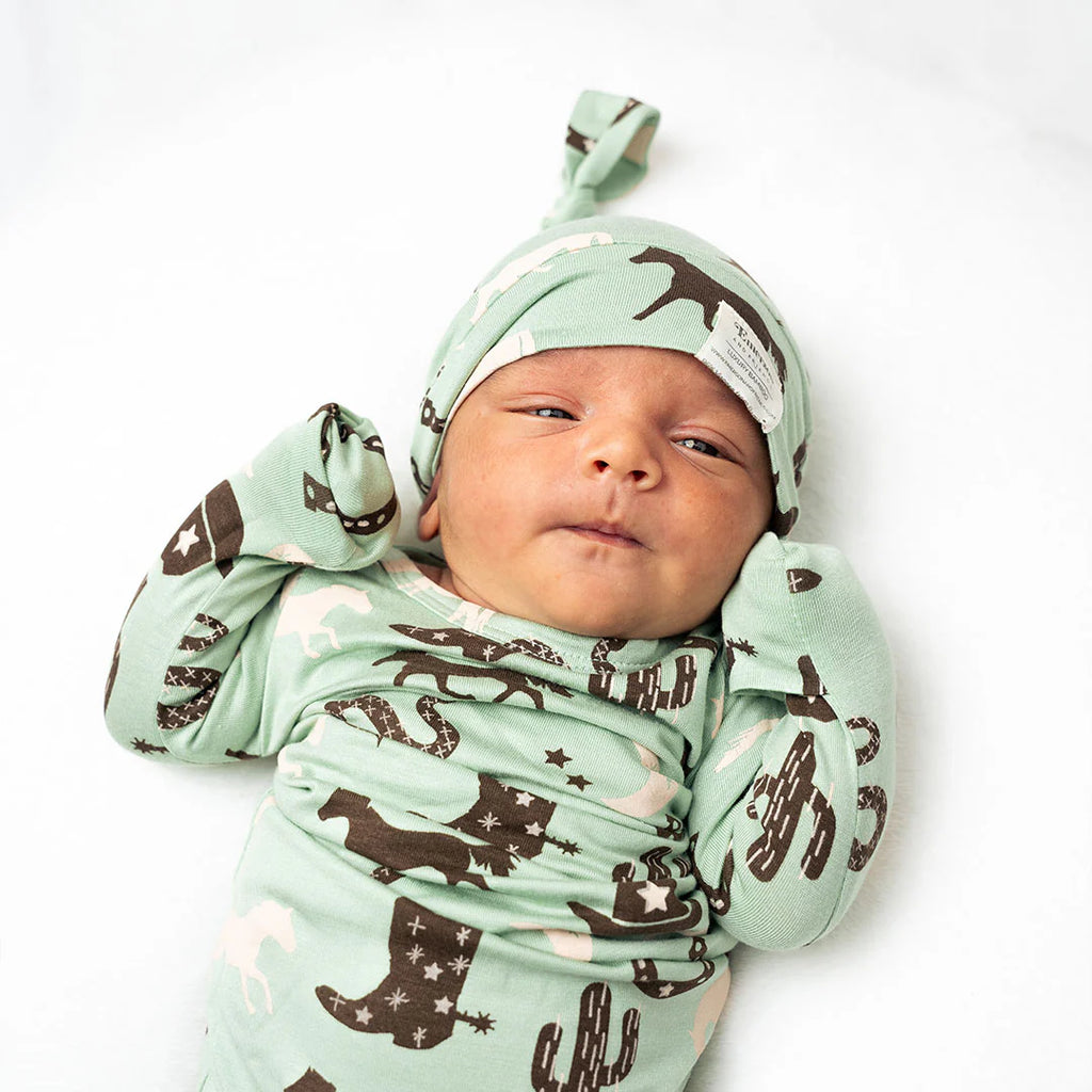 giddyup newborn baby bamboo gown and hat set on a white background